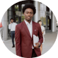 An experienced male business advisor in a maroon suit, ready to offer strategic consultation for a business owner.