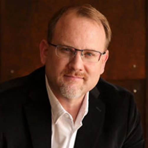 Professional portrait of Scott McGrath, the CEO, dedicated to helping clients achieve their business sale and wealth goals.